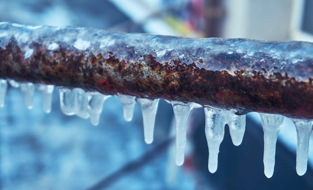 Close Up Of A Frozen Pipe With Small Icicles