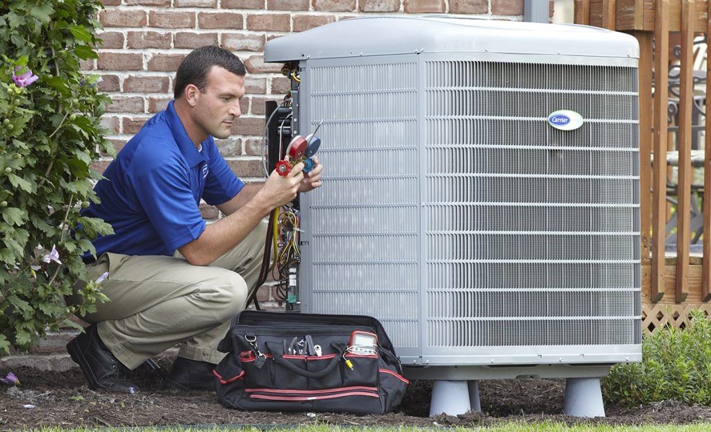 Technician Checking Gauges For Outdoor Air Conditioner Unit